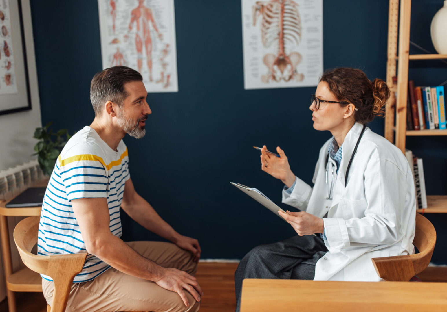 Female doctor consulting male patient in clinic